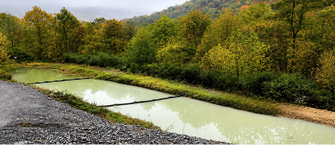 Floating Water Baffles for Pond Flow Control and Water Treatment Floating Water Baffles installed in a treatment pond to help control water flow, improve circulation, and support sediment and water quality management.