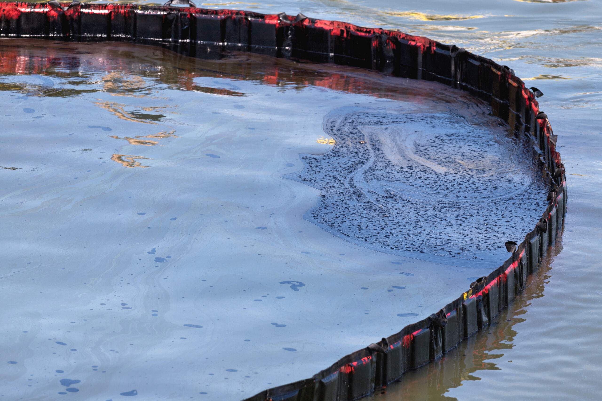 Oil Fence Boom deployed on water to contain an oil slick and prevent surface pollutants from spreading into surrounding waterways.